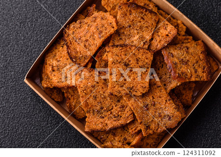 Crispy homemade brown bread chips with seeds and grains Crispy homemade brown bread chips with seeds and grains 124311092