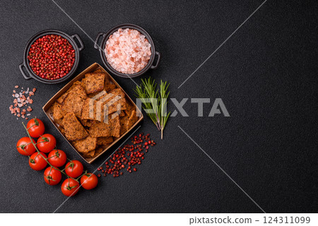Crispy homemade brown bread chips with seeds and grains Crispy homemade brown bread chips with seeds and grains 124311099