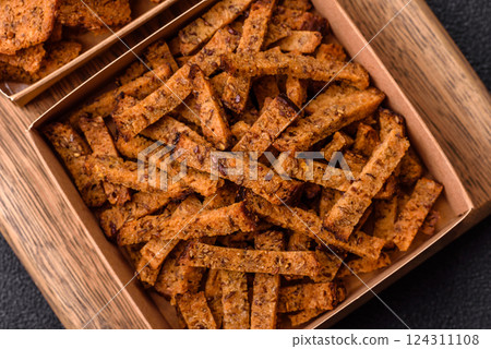 Crispy homemade brown bread crackers or croutons with seeds and grains 124311108