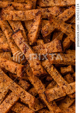 Crispy homemade brown bread crackers or croutons with seeds and grains Crispy homemade brown bread crackers or croutons with seeds and grains 124311114