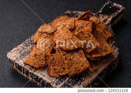 Crispy homemade brown bread chips with seeds and grains Crispy homemade brown bread chips with seeds and grains 124311120