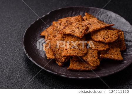 Crispy homemade brown bread chips with seeds and grains Crispy homemade brown bread chips with seeds and grains 124311130