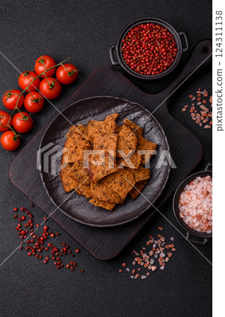 Crispy homemade brown bread chips with seeds and grains Crispy homemade brown bread chips with seeds and grains 124311138