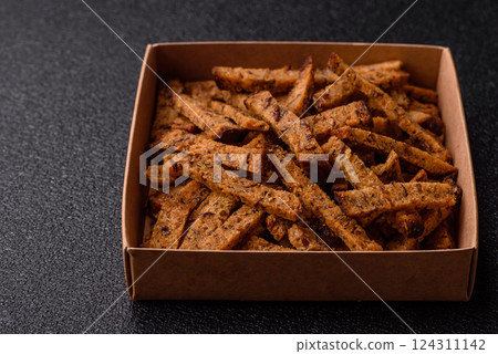 Crispy homemade brown bread crackers or croutons with seeds and grains Crispy homemade brown bread crackers or croutons with seeds and grains 124311142