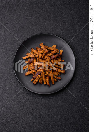 Crispy homemade brown bread crackers or croutons with seeds and grains 124311164