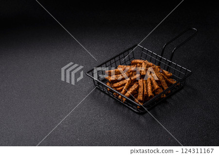 Crispy homemade brown bread crackers or croutons with seeds and grains 124311167