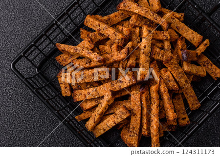 Crispy homemade brown bread crackers or croutons with seeds and grains 124311173