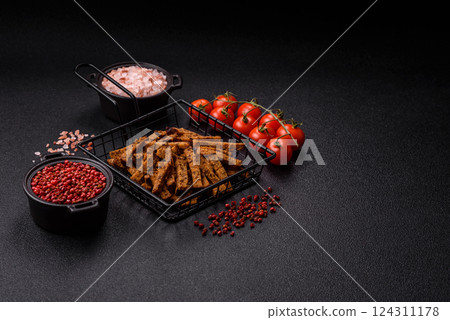 Crispy homemade brown bread crackers or croutons with seeds and grains 124311178