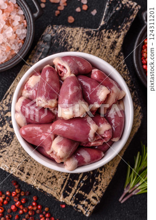 Raw chicken hearts with salt, spices and herbs 124311201
