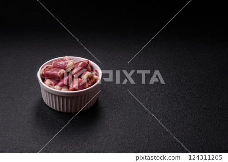Raw chicken hearts with salt, spices and herbs 124311205