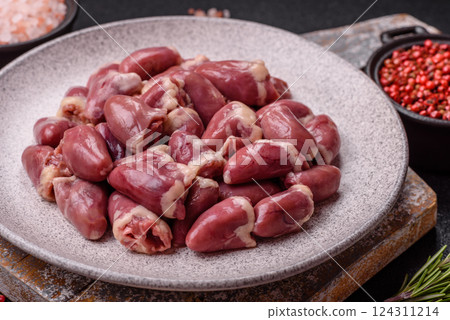 Raw chicken hearts with salt, spices and herbs 124311214