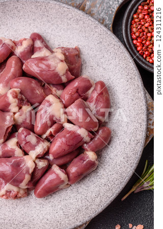 Raw chicken hearts with salt, spices and herbs 124311216