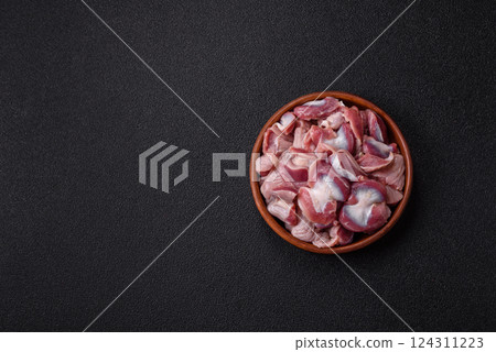 Raw chicken or turkey gizzards with salt, spices and herbs Raw chicken or turkey gizzards with salt, spices and herbs 124311223