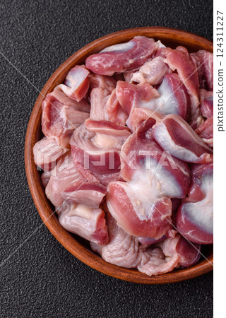 Raw chicken or turkey gizzards with salt, spices and herbs Raw chicken or turkey gizzards with salt, spices and herbs 124311227