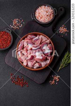Raw chicken or turkey gizzards with salt, spices and herbs Raw chicken or turkey gizzards with salt, spices and herbs 124311233