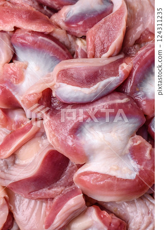Raw chicken or turkey gizzards with salt, spices and herbs Raw chicken or turkey gizzards with salt, spices and herbs 124311235