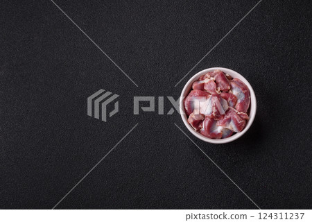 Raw chicken or turkey gizzards with salt, spices and herbs Raw chicken or turkey gizzards with salt, spices and herbs 124311237