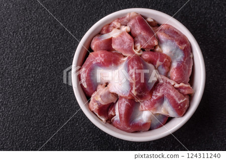 Raw chicken or turkey gizzards with salt, spices and herbs Raw chicken or turkey gizzards with salt, spices and herbs 124311240