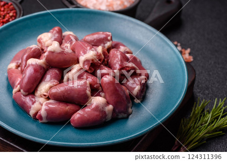 Raw chicken hearts with salt, spices and herbs Raw chicken hearts with salt, spices and herbs 124311396