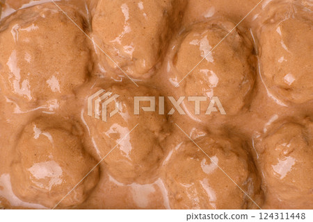 Meatballs with salt and spices in creamy caramel sauce 124311448