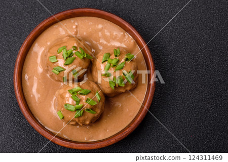 Meatballs with salt and spices in creamy caramel sauce 124311469