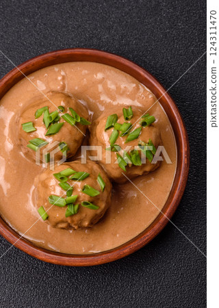 Meatballs with salt and spices in creamy caramel sauce Meatballs with salt and spices in creamy caramel sauce 124311470