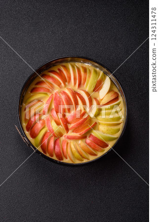 Raw sweet apple pie in a mold prepared for baking 124311478