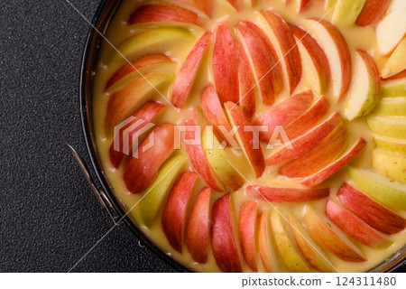 Raw sweet apple pie in a mold prepared for baking 124311480
