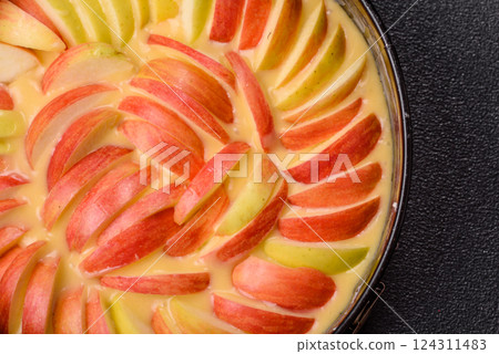 Raw sweet apple pie in a mold prepared for baking 124311483