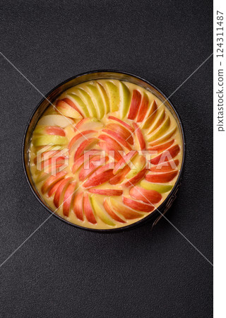 Raw sweet apple pie in a mold prepared for baking 124311487