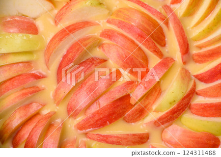Raw sweet apple pie in a mold prepared for baking Raw sweet apple pie in a mold prepared for baking 124311488