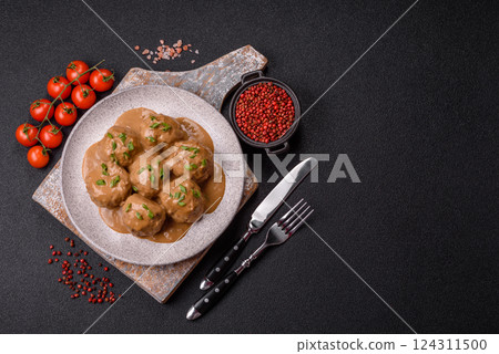 Meatballs with salt and spices in creamy caramel sauce Meatballs with salt and spices in creamy caramel sauce 124311500