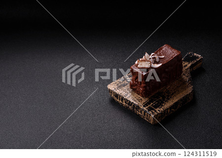 Piece of sweet chocolate bounty cake with coconut flakes and sponge Piece of sweet chocolate bounty cake with coconut flakes and sponge 124311519