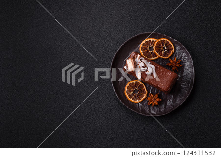 Piece of sweet chocolate bounty cake with coconut flakes and sponge 124311532