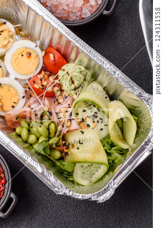 Healthy breakfast consisting of boiled eggs, slices of ham, tomatoes, green beans, aioli sauce 124311558