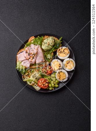 Healthy breakfast consisting of boiled eggs, slices of ham, tomatoes, green beans, aioli sauce Healthy breakfast consisting of boiled eggs, slices of ham, tomatoes, green beans, aioli sauce 124311564