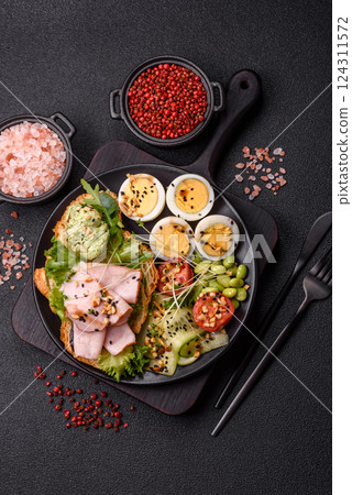 Healthy breakfast consisting of boiled eggs, slices of ham, tomatoes, green beans, aioli sauce Healthy breakfast consisting of boiled eggs, slices of ham, tomatoes, green beans, aioli sauce 124311572