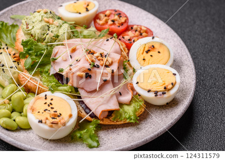 Healthy breakfast consisting of boiled eggs, slices of ham, tomatoes, green beans, aioli sauce Healthy breakfast consisting of boiled eggs, slices of ham, tomatoes, green beans, aioli sauce 124311579