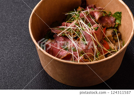 Warm salad consisting of slices of roast beef, greens, tomatoes, cucumbers, green beans Warm salad consisting of slices of roast beef, greens, tomatoes, cucumbers, green beans 124311587