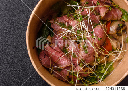 Warm salad consisting of slices of roast beef, greens, tomatoes, cucumbers, green beans Warm salad consisting of slices of roast beef, greens, tomatoes, cucumbers, green beans 124311588