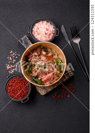 Warm salad consisting of slices of roast beef, greens, tomatoes, cucumbers, green beans 124311595