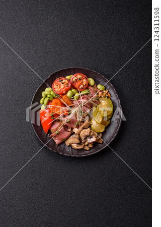 Warm salad consisting of slices of roast beef, greens, tomatoes, cucumbers, green beans Warm salad consisting of slices of roast beef, greens, tomatoes, cucumbers, green beans 124311598