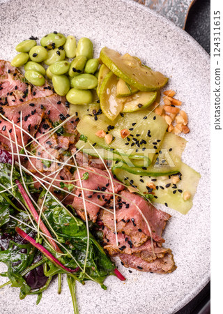 Warm salad consisting of slices of roast beef, greens, tomatoes, cucumbers, green beans Warm salad consisting of slices of roast beef, greens, tomatoes, cucumbers, green beans 124311615
