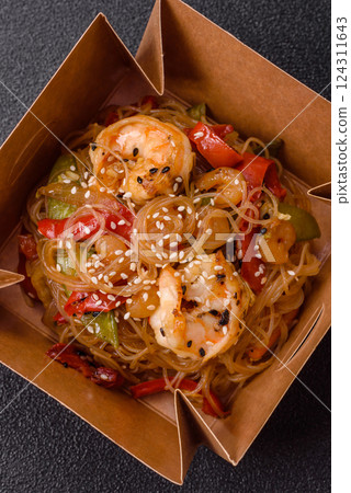 Glass noodles with shrimps and seafood, vegetables, spices and soy sauce 124311643