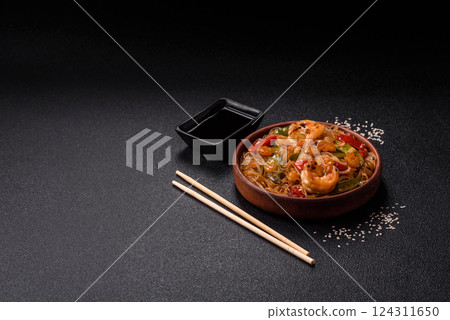 Glass noodles with shrimps and seafood, vegetables, spices and soy sauce 124311650