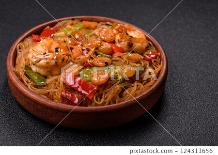 Glass noodles with shrimps and seafood, vegetables, spices and soy sauce 124311656