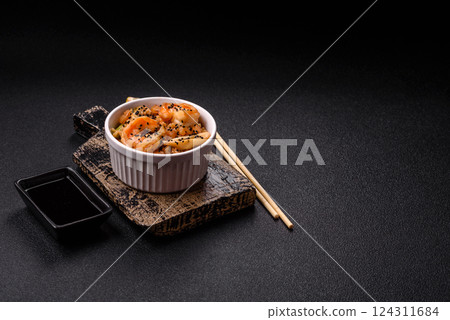 Rice with shrimps and seafood, vegetables, spices and soy sauce Rice with shrimps and seafood, vegetables, spices and soy sauce 124311684
