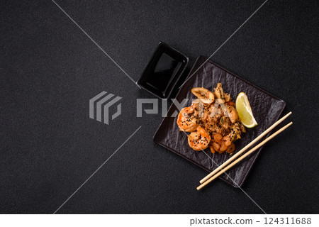 Rice with shrimps and seafood, vegetables, spices and soy sauce Rice with shrimps and seafood, vegetables, spices and soy sauce 124311688