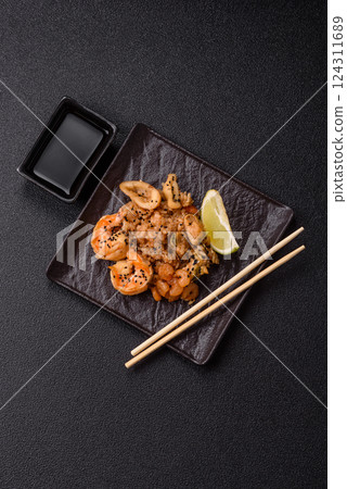 Rice with shrimps and seafood, vegetables, spices and soy sauce Rice with shrimps and seafood, vegetables, spices and soy sauce 124311689