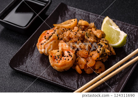 Rice with shrimps and seafood, vegetables, spices and soy sauce 124311690